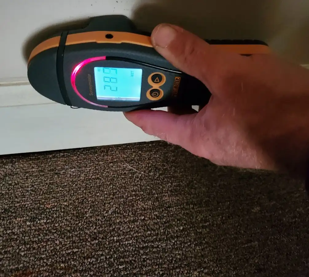 Moisture detection at baseboard during Storm Damage Restoration in Woodruff